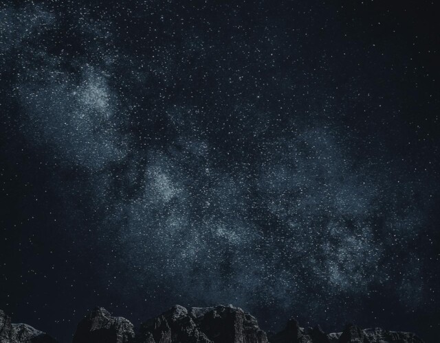 Star-filled night sky over mountains Starry sky with Milky Way over mountains