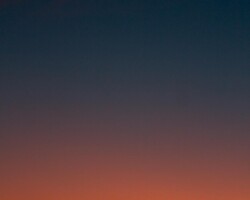 Fiery sunset with crescent moon Crescent moon and fiery orange sunset horizon