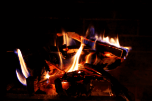 Crackling fire burning warmly in a fireplace Crackling fireplace with glowing logs and bright orange flames