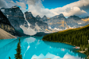 Snow-capped peaks reflected in turquoise lake Turquoise mountain lake reflecting snow-capped peaks